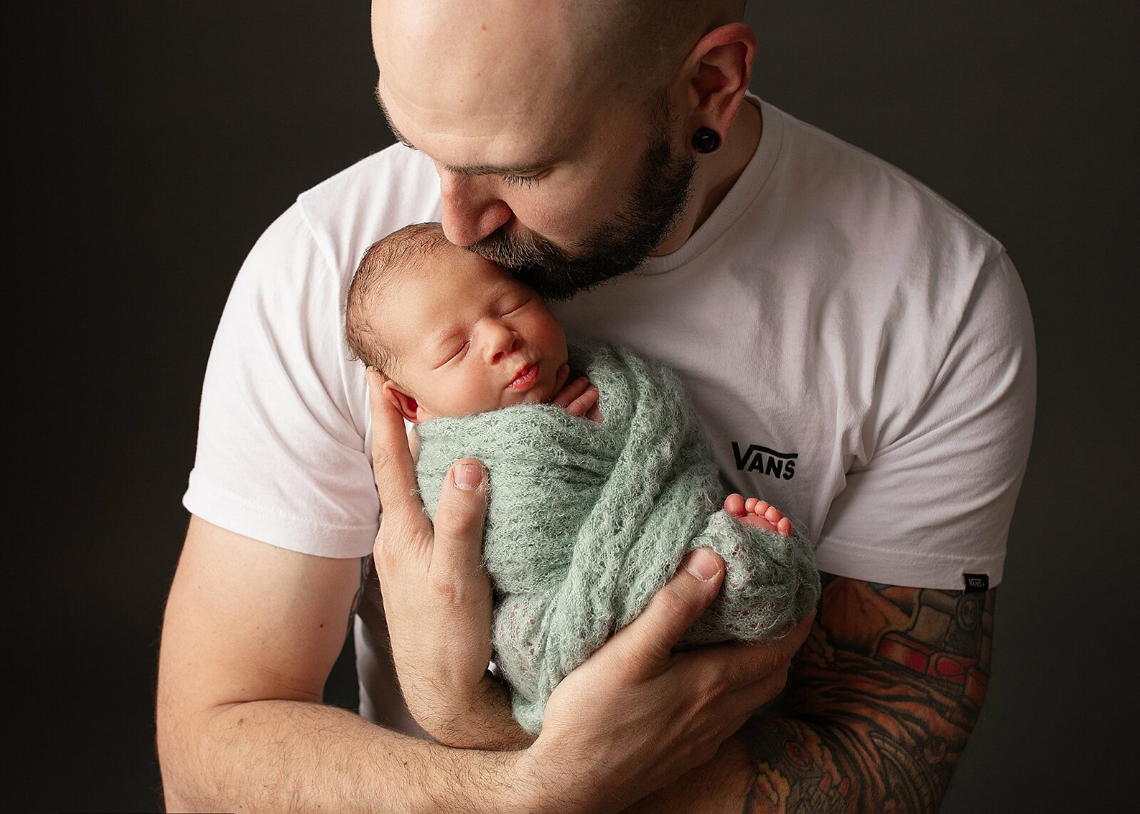 newborn baby boy sleeping in dads arms. photo studio hereford, Herefordshire, cheltenham